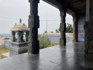 a view over the town from the front porch of a small temple