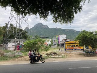 an indian scene with a motorbike and some kids playing