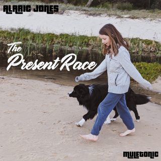 Cover of the album 'The Present Race' of a young girl and a dog walking on a beach.