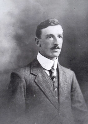 An old photo of a nicely dressed man with a moustache